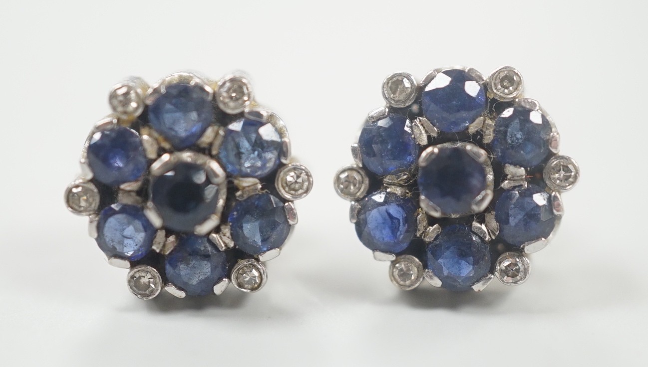 A pair of white metal, sapphire and diamond cluster set flower head ear studs, 10mm, gross weight 4.6 grams.